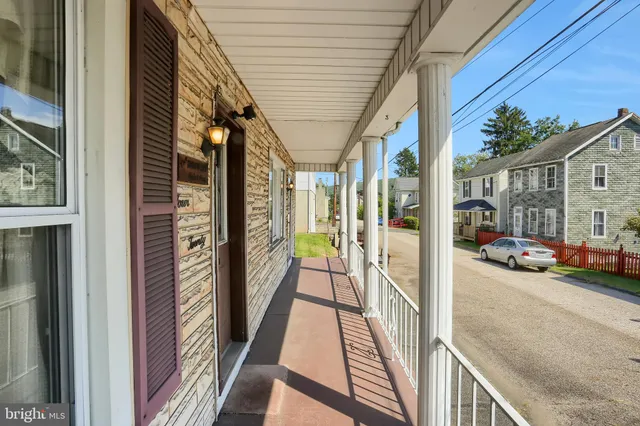 a view of a balcony and car parked