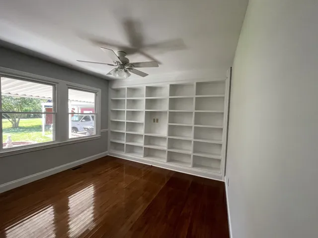 wooden floor in an empty room with a window