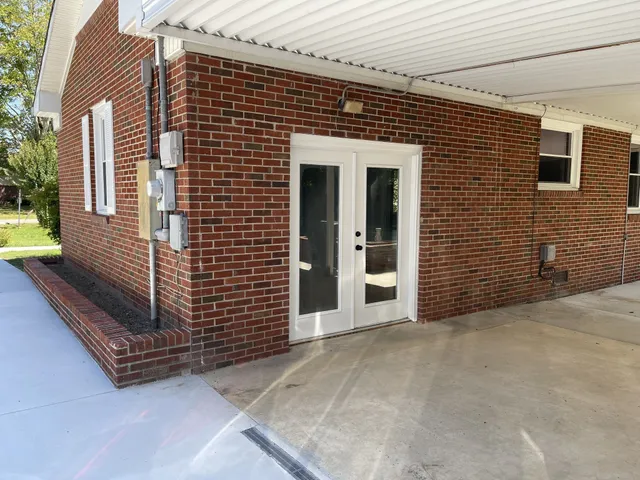 a view of a patio with a dining table and chairs
