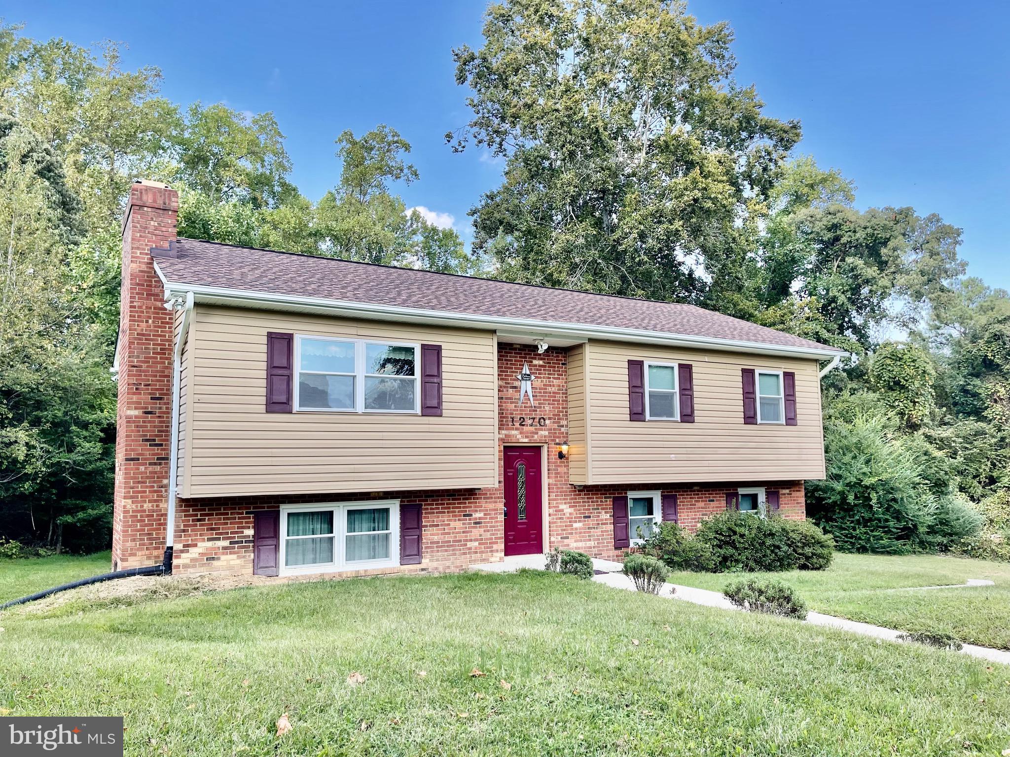 1270 Calvert Beach Road St. Leonard, MD 20685 - Photo 1 of 31 a front view of a house with a garden