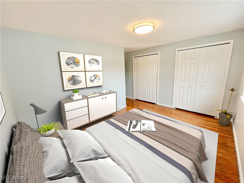 2868 Noble Road, Unit 16 Cleveland, OH 44121 - Photo 5 of 6 Bedroom featuring wood finished floors and multiple closets