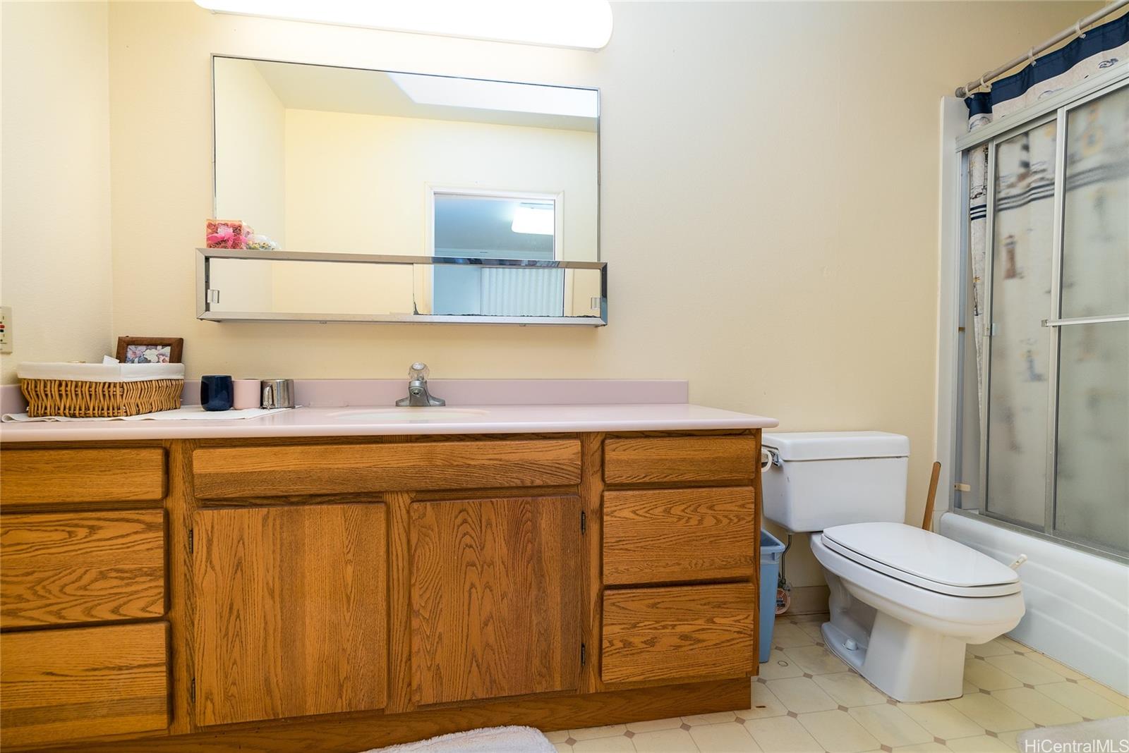 87-201 Paakea Road Waianae, HI 96792 - Photo 13 of 19 a bathroom with a sink a toilet and mirror