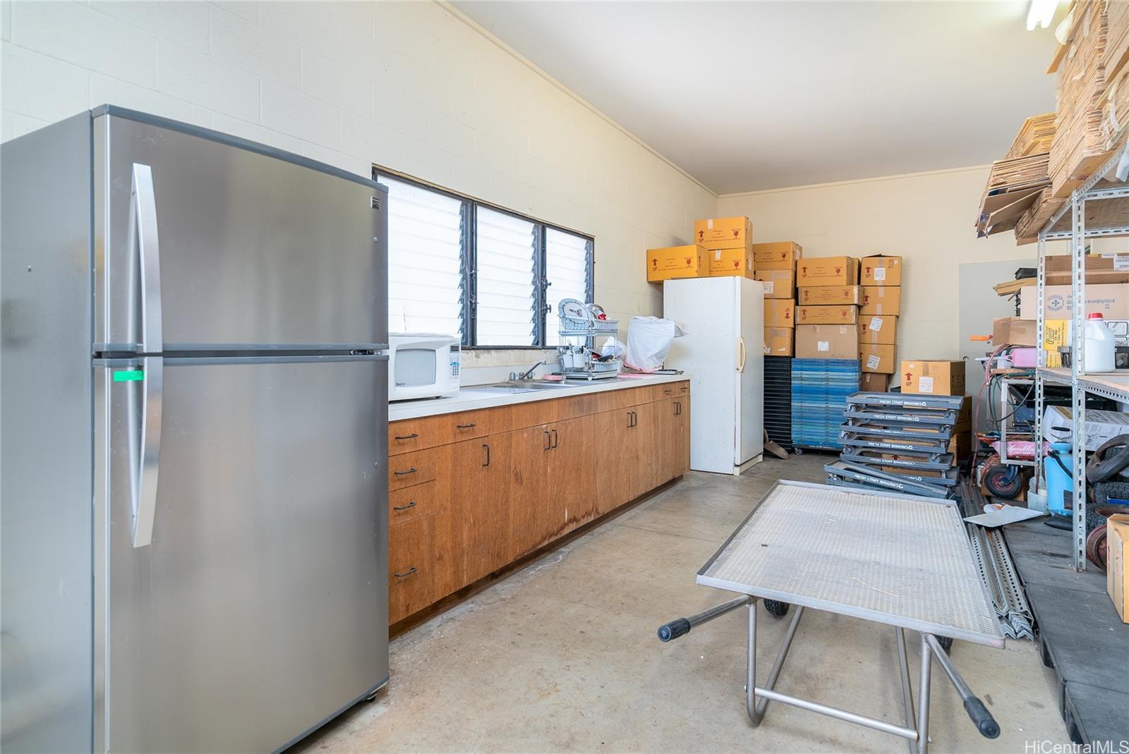 87-201 Paakea Road Waianae, HI 96792 - Photo 16 of 19 a kitchen with stainless steel appliances a refrigerator sink and cabinets