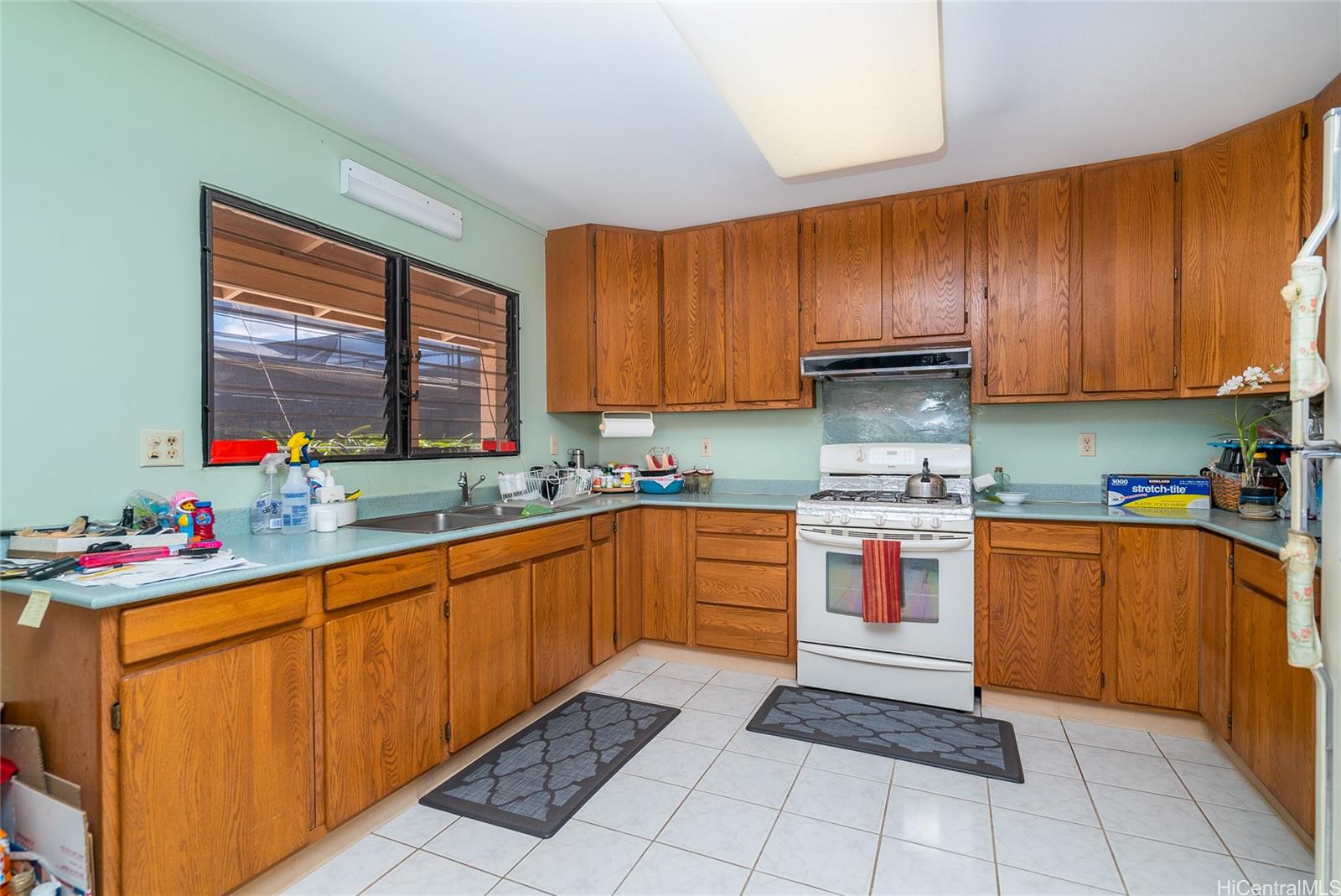 87-201 Paakea Road Waianae, HI 96792 - Photo 7 of 19 a kitchen with stainless steel appliances granite countertop sink stove and cabinets