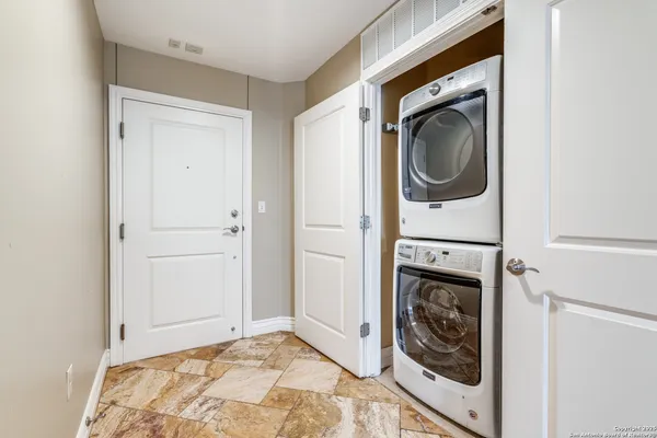 a view of a bedroom with washer and dryer