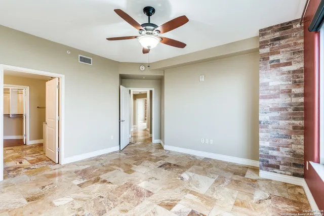 a view of a big room with a chandelier fan and entryway