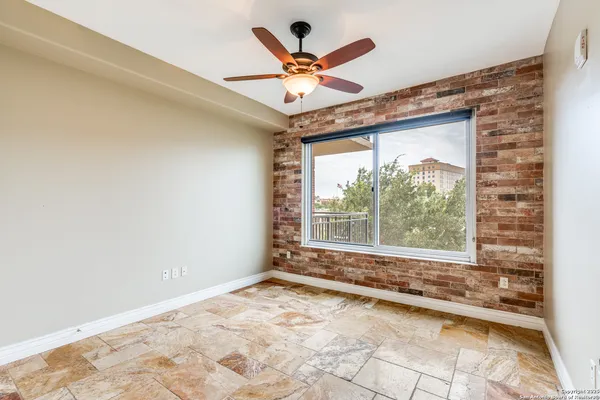 a view of a livingroom with a ceiling fan and window