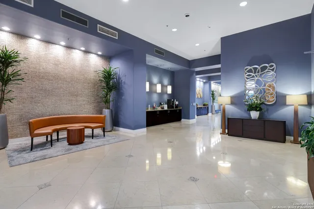 a lobby with furniture and potted plant