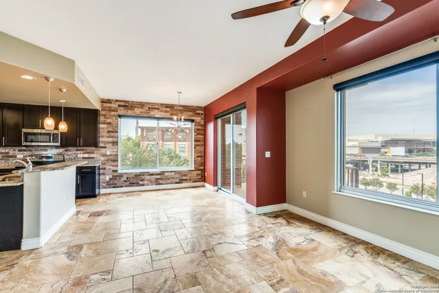 a open kitchen with stainless steel appliances granite countertop a stove and a refrigerator