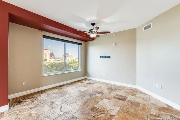 a view of an empty room with a window