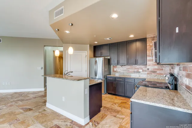 a kitchen with stainless steel appliances granite countertop wooden cabinets a sink and dishwasher