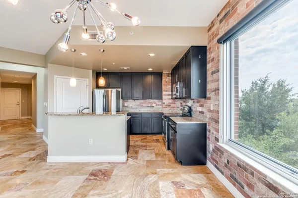 a large kitchen with a table and chairs