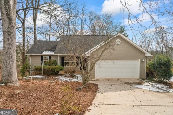 a view of a house with a yard covered with snow