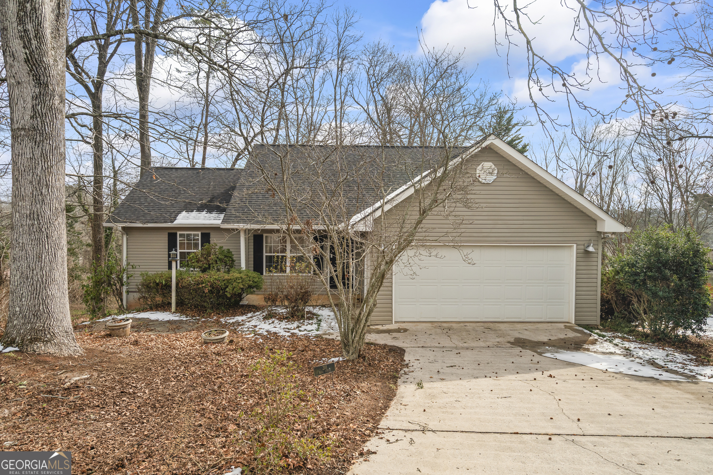 a view of a house with a yard covered with snow