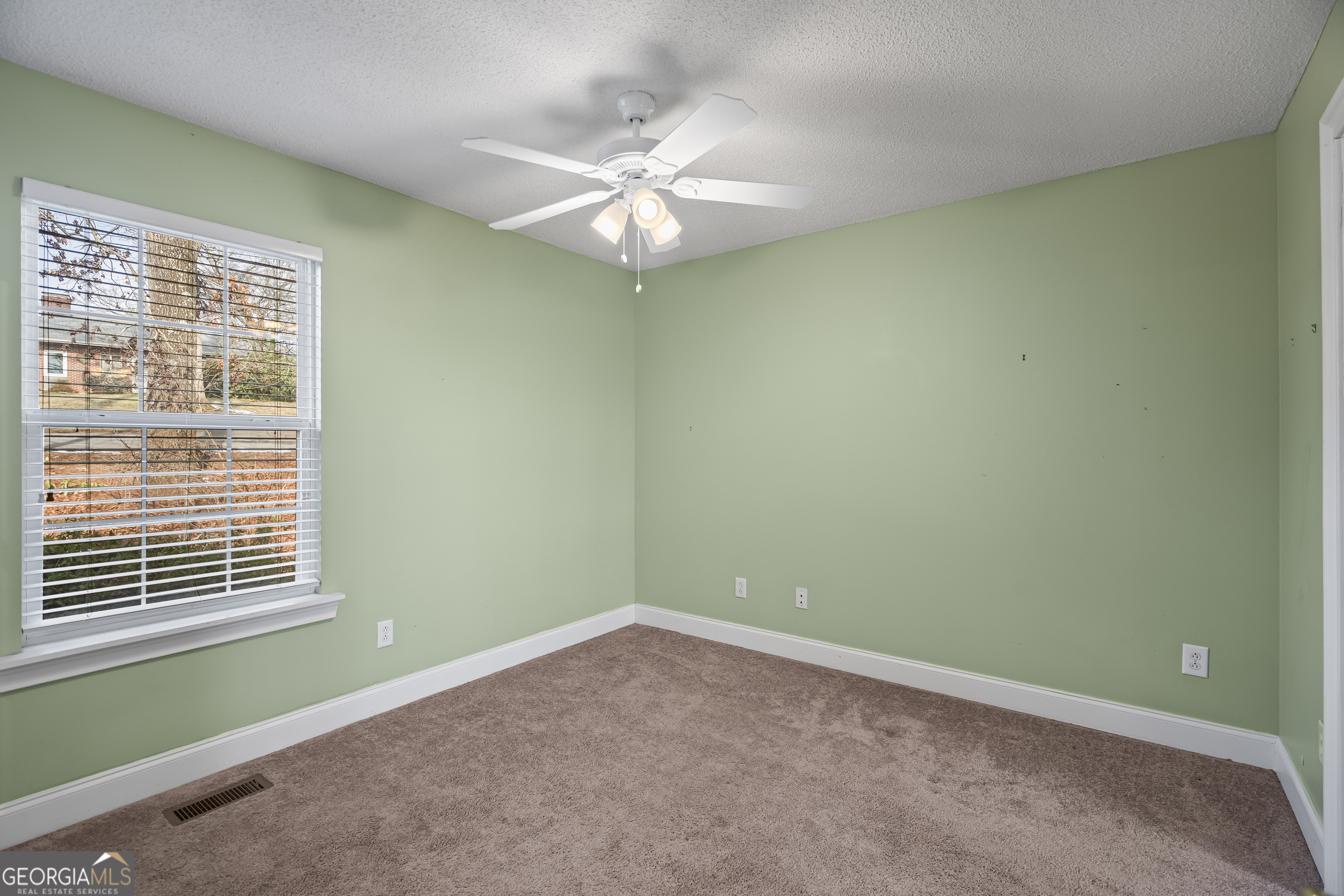 210 Blue Ridge Avenue Demorest, GA 30535 - Photo 16 of 74 en empty room with window and fan