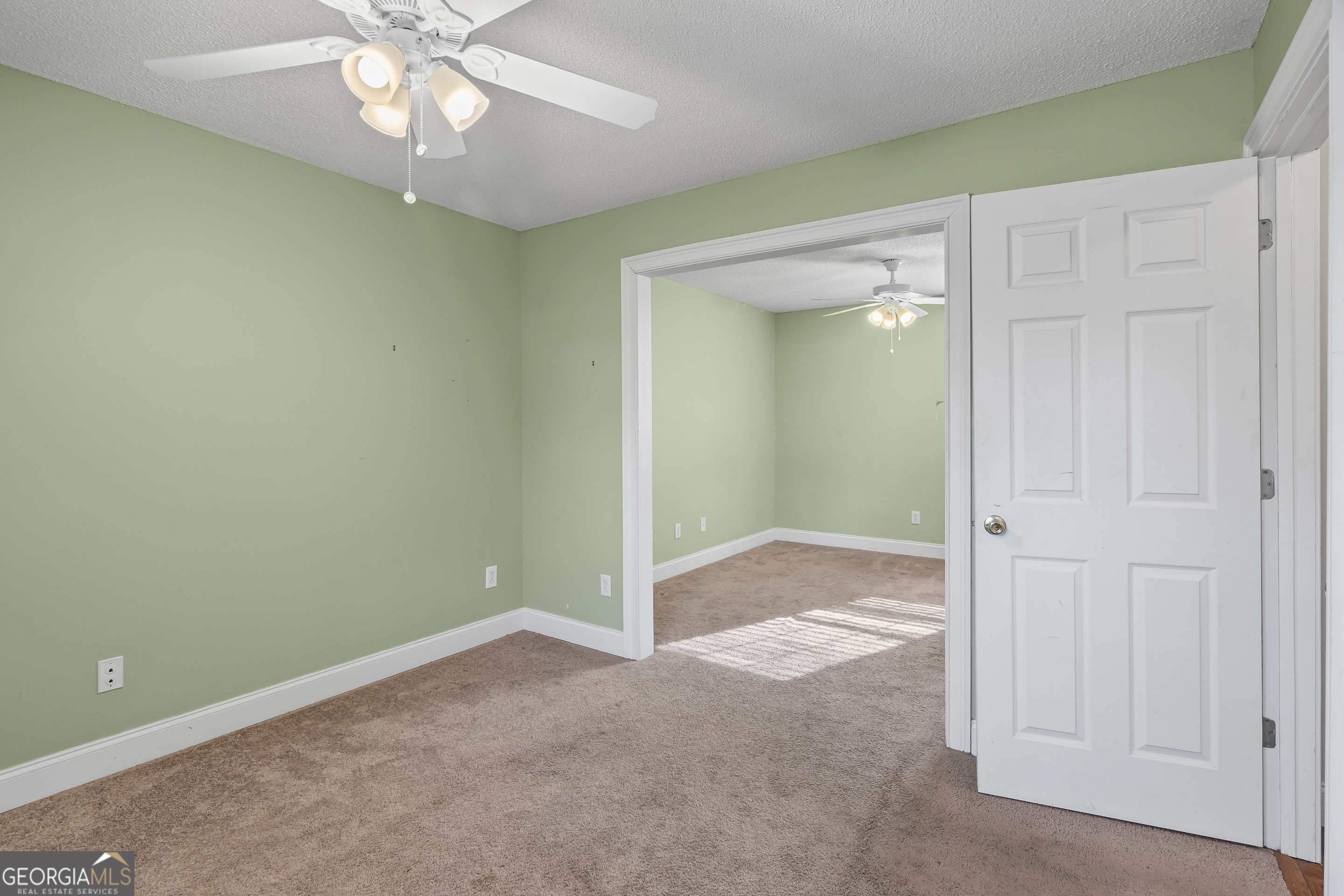 210 Blue Ridge Avenue Demorest, GA 30535 - Photo 17 of 74 an empty room with a chandelier fan and a chandelier fan