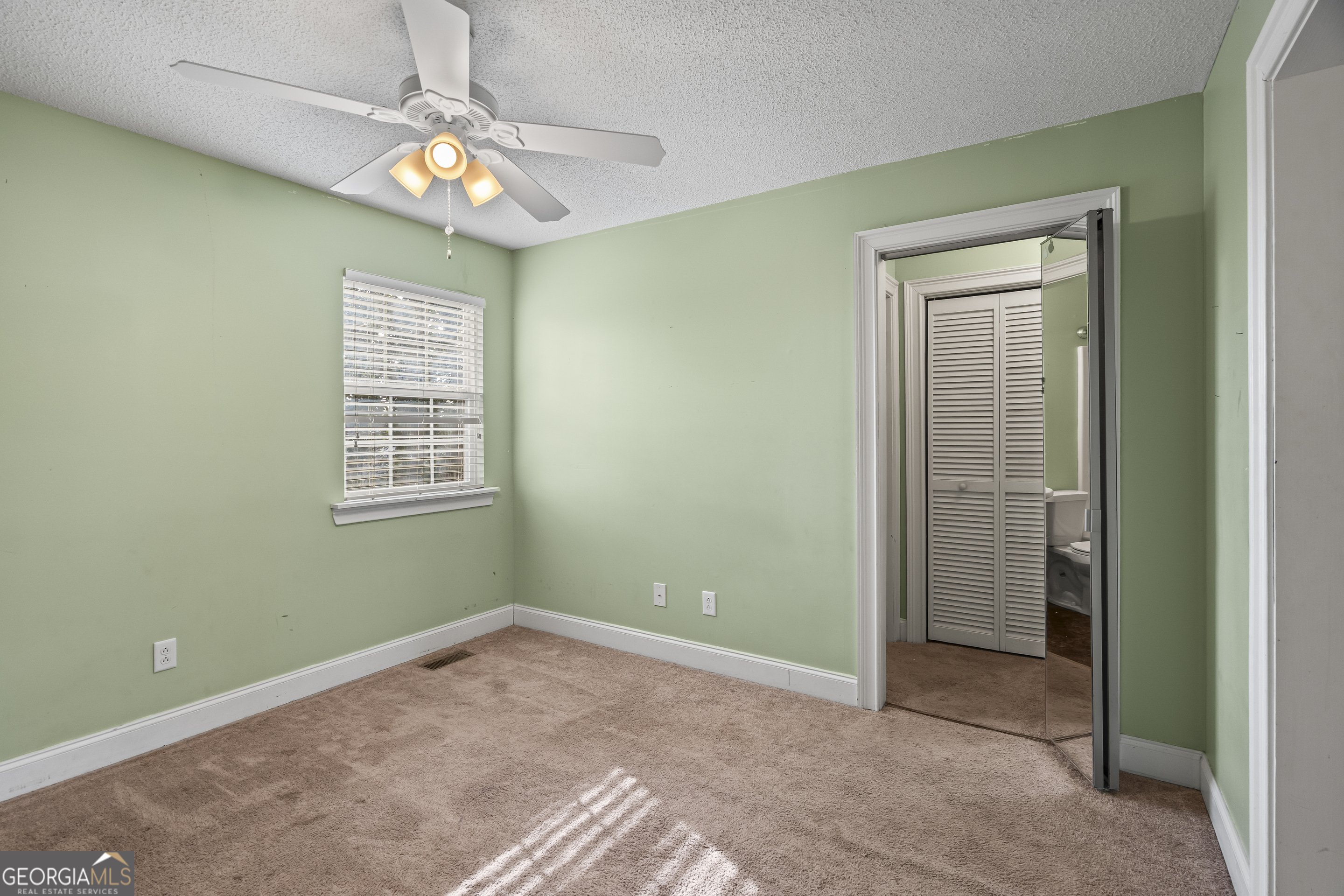 210 Blue Ridge Avenue Demorest, GA 30535 - Photo 20 of 74 en empty room with windows and ceiling fan