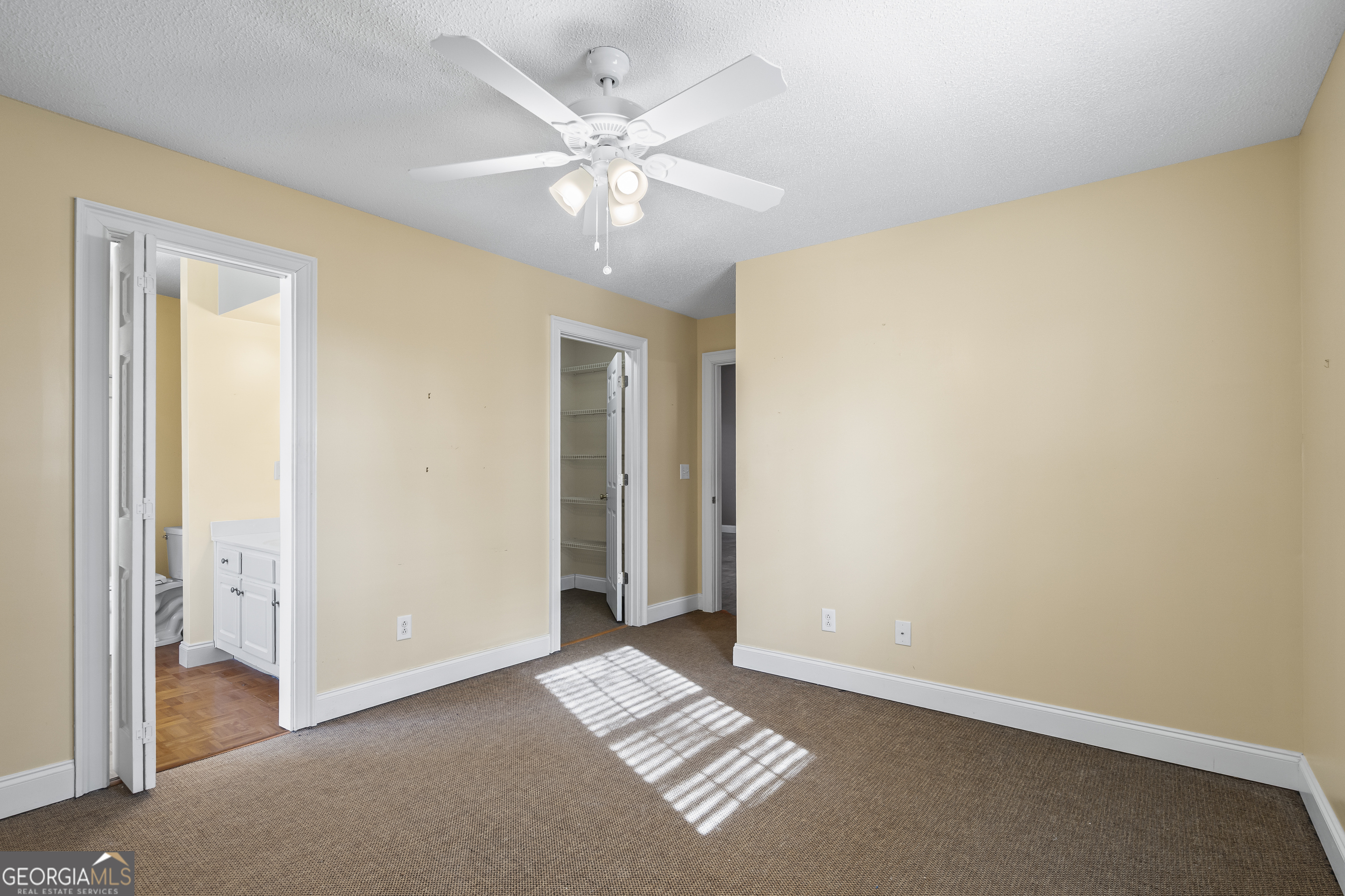 210 Blue Ridge Avenue Demorest, GA 30535 - Photo 27 of 74 an empty room with a ceiling fan and a window