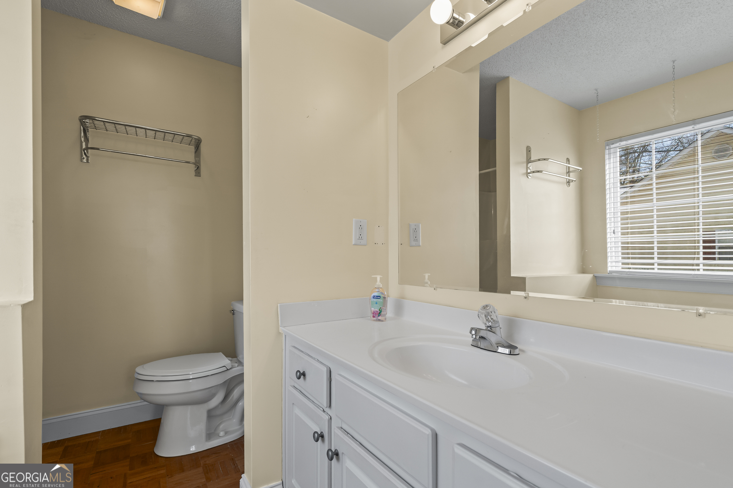 210 Blue Ridge Avenue Demorest, GA 30535 - Photo 28 of 74 a bathroom with a granite countertop sink toilet a large mirror and shower