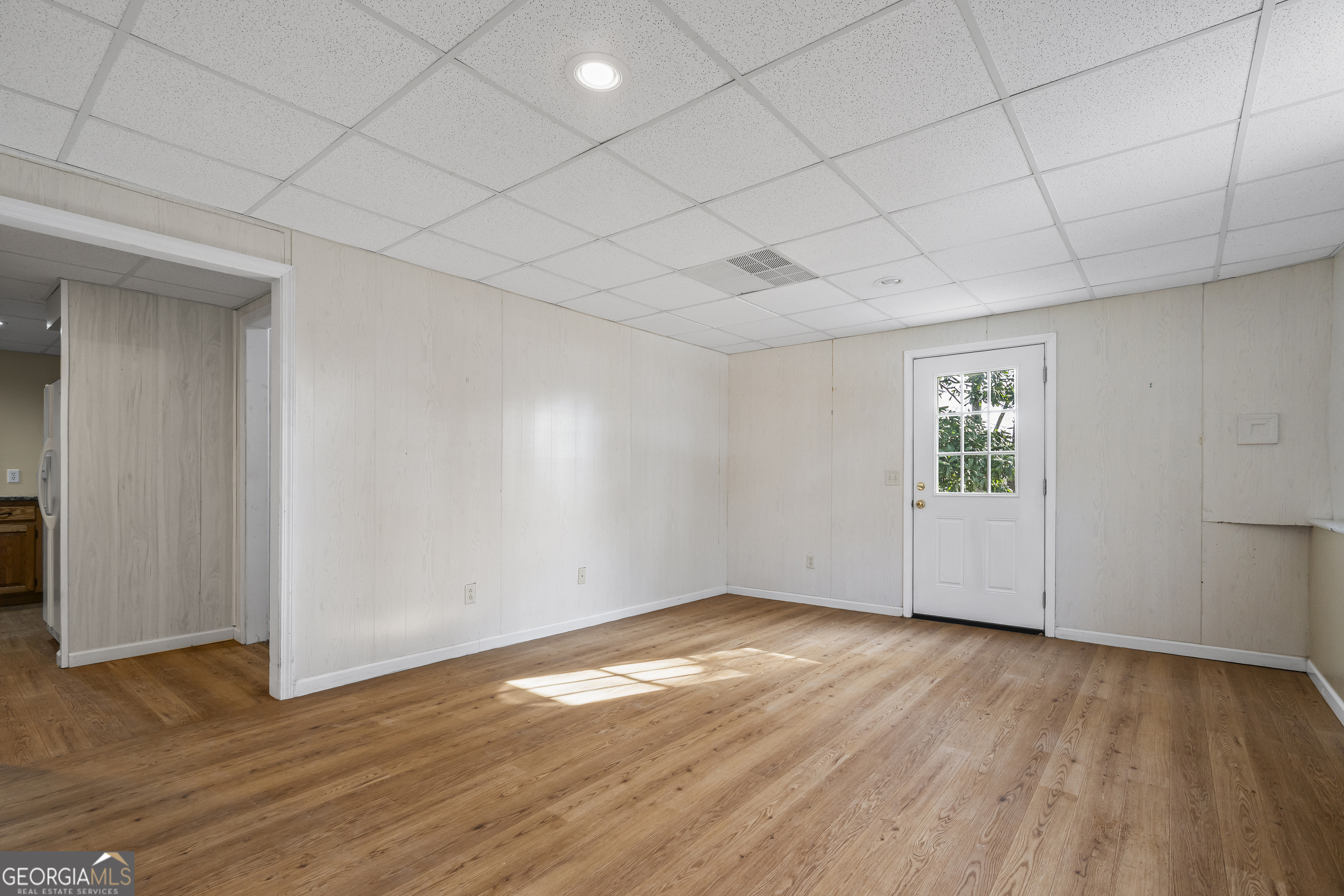 210 Blue Ridge Avenue Demorest, GA 30535 - Photo 32 of 74 an empty room with wooden floor and windows