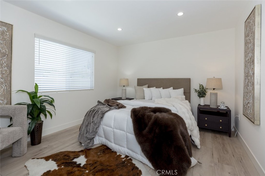 15254 Clymer Street Mission Hills, CA 91345 - Photo 13 of 26 a bedroom with a bed and a potted plant