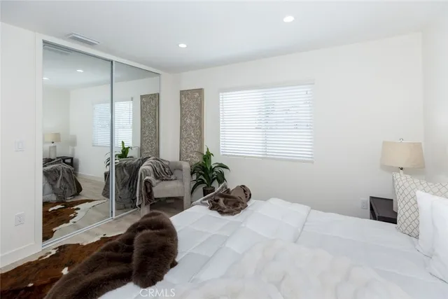 a bedroom with furniture and a large window