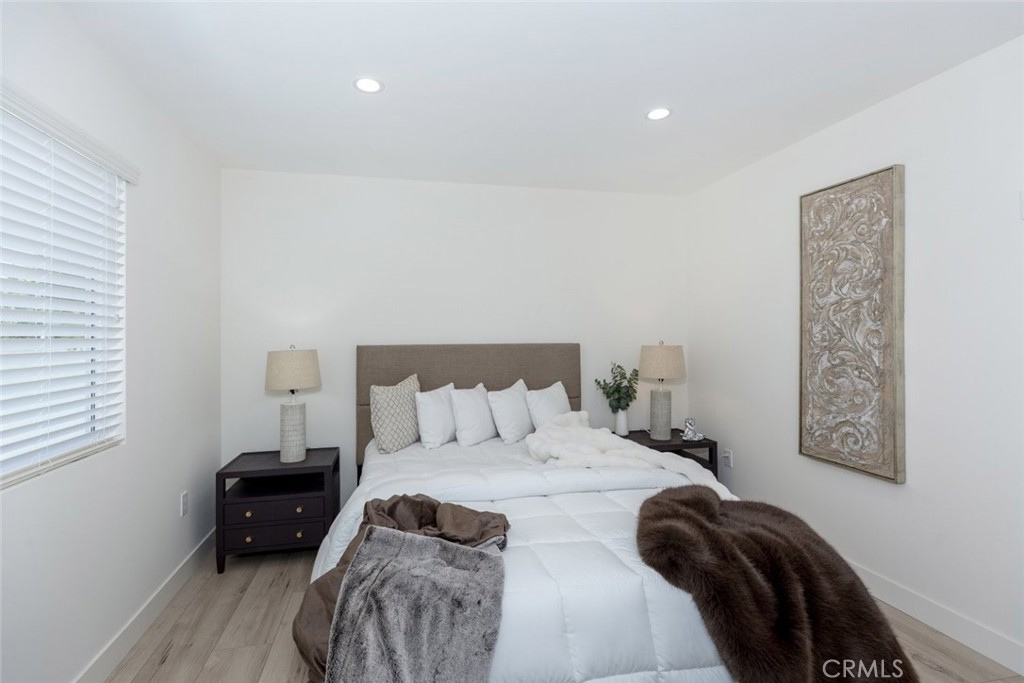 15254 Clymer Street Mission Hills, CA 91345 - Photo 15 of 26 a bedroom with a bed and a window