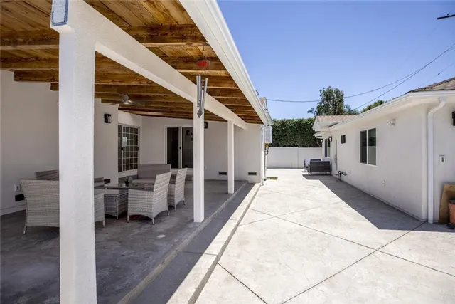 a view of a patio with couches and potted plants