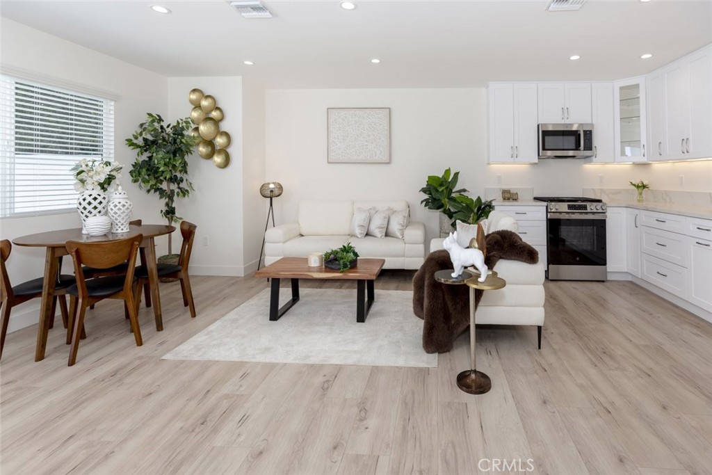 15254 Clymer Street Mission Hills, CA 91345 - Photo 5 of 26 a living room with furniture wooden floor and a potted plant