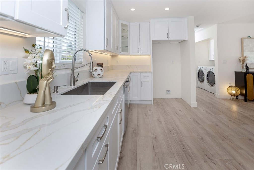15254 Clymer Street Mission Hills, CA 91345 - Photo 7 of 26 a kitchen with stainless steel appliances granite countertop a sink a stove top oven a counter space and cabinets