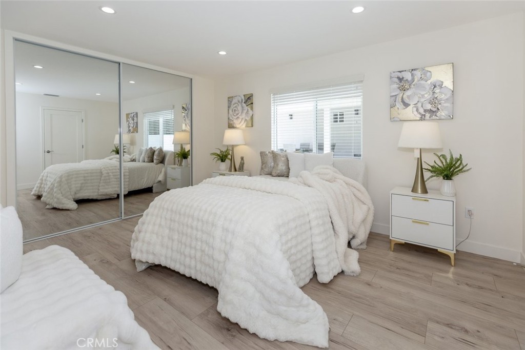 15254 Clymer Street Mission Hills, CA 91345 - Photo 9 of 26 a spacious bedroom with a bed and a couch