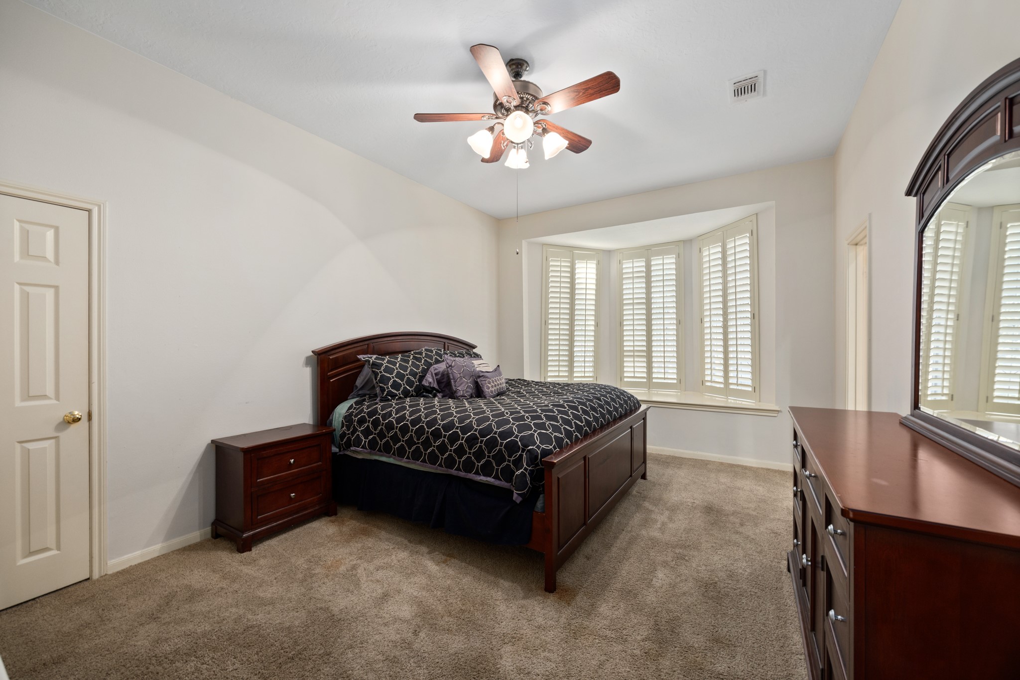 8807 Chelmsford Lane Spring, TX 77379 - Photo 33 of 50 At 20' x 12' the huge upstairs secondary bedroom features an ensuite bath and views of the front yard through the plantation shutters.