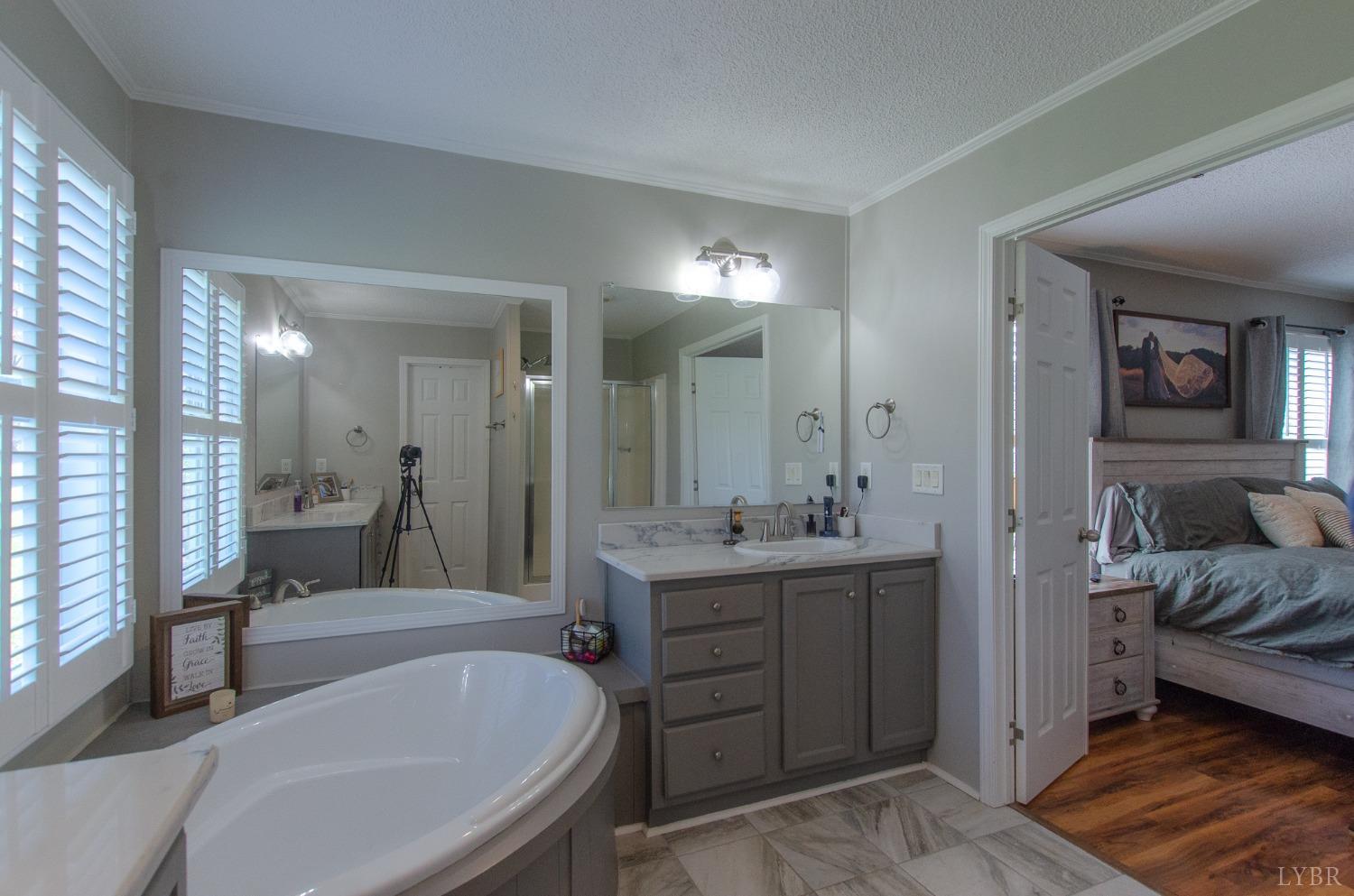 309 Lakeside Road Penhook, VA 24137 - Photo 26 of 61 a spacious bathroom with a tub sink and mirror