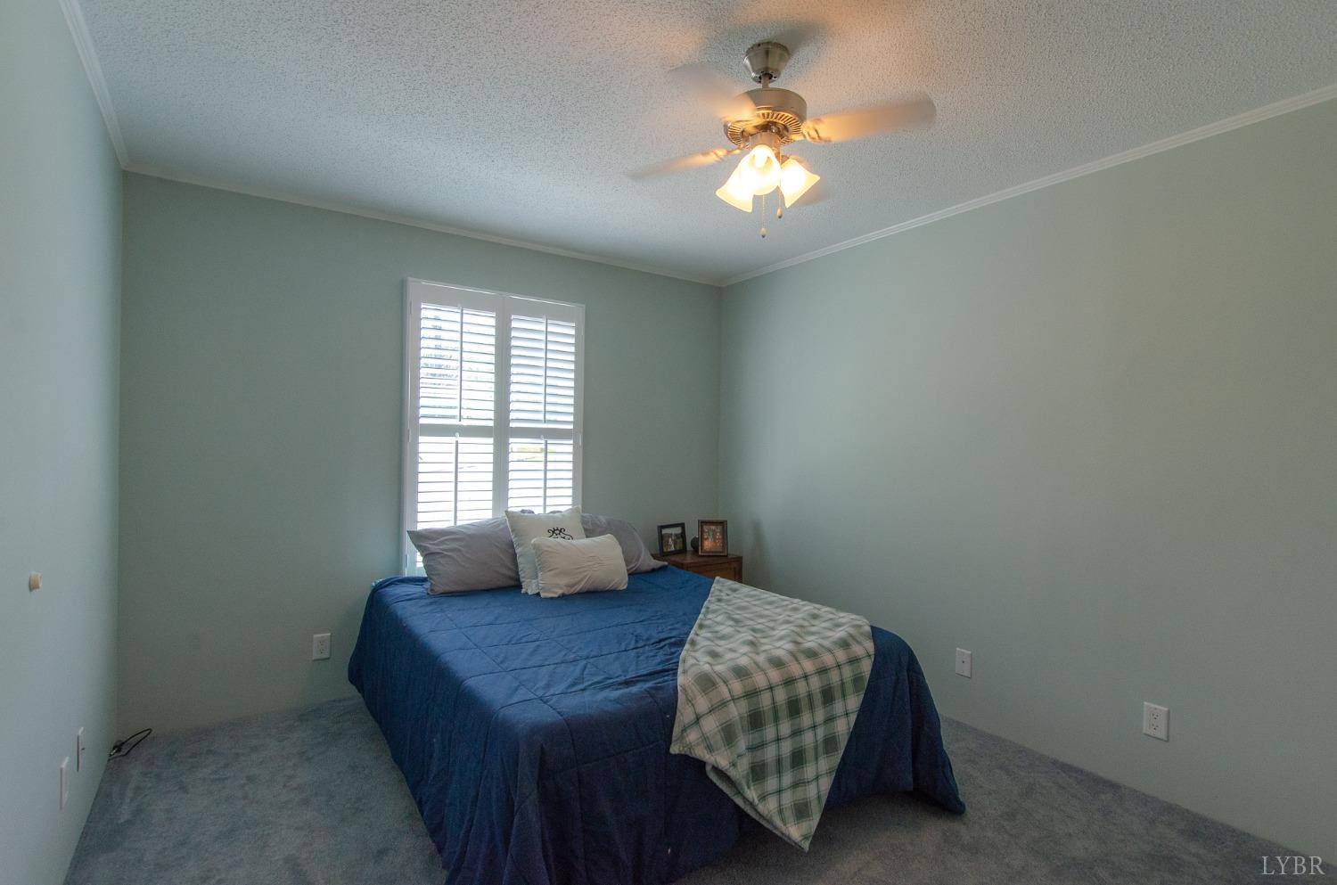 309 Lakeside Road Penhook, VA 24137 - Photo 31 of 61 a bedroom with a bed and a chandelier