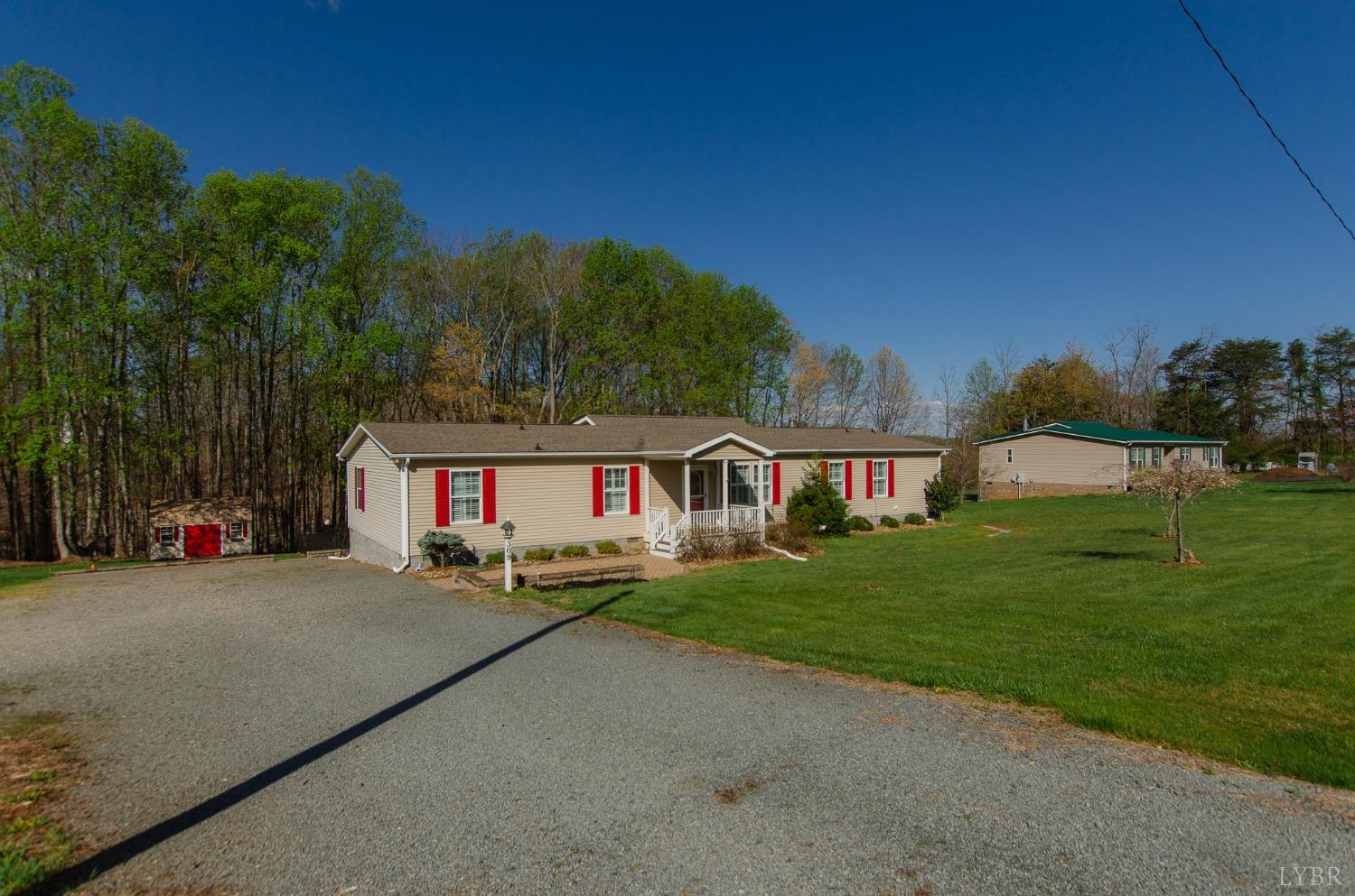 309 Lakeside Road Penhook, VA 24137 - Photo 40 of 61 a front view of a house with a yard and trees