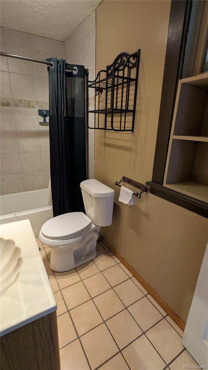 3924 Jason Street Denver, CO 80211 - Photo 20 of 26 a bathroom with a toilet a sink and shower