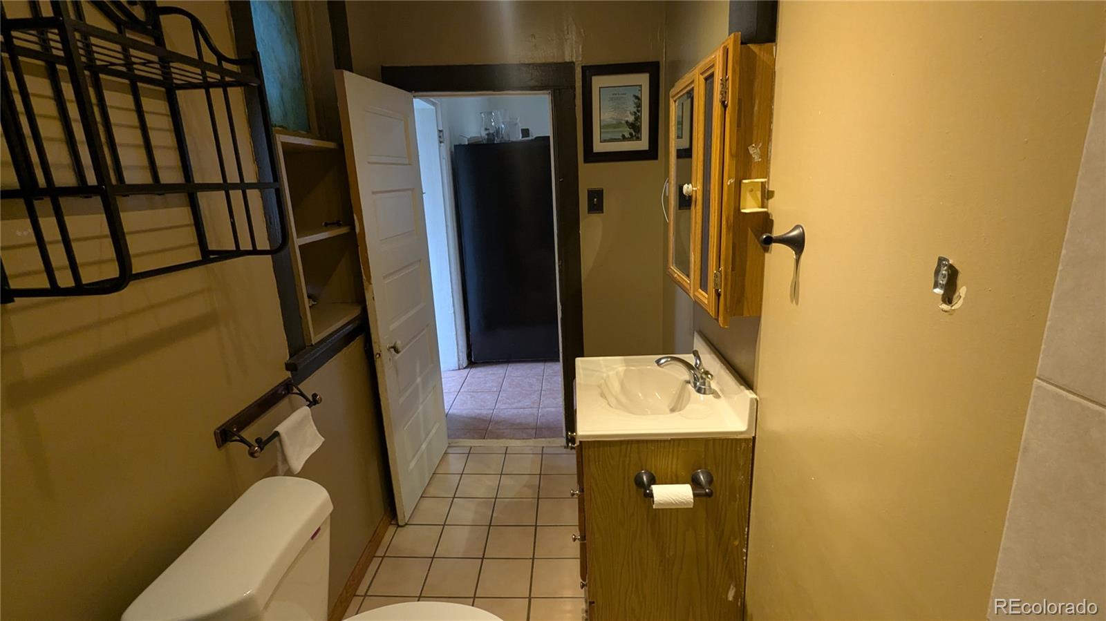 3924 Jason Street Denver, CO 80211 - Photo 21 of 26 a bathroom with a sink a toilet and shower