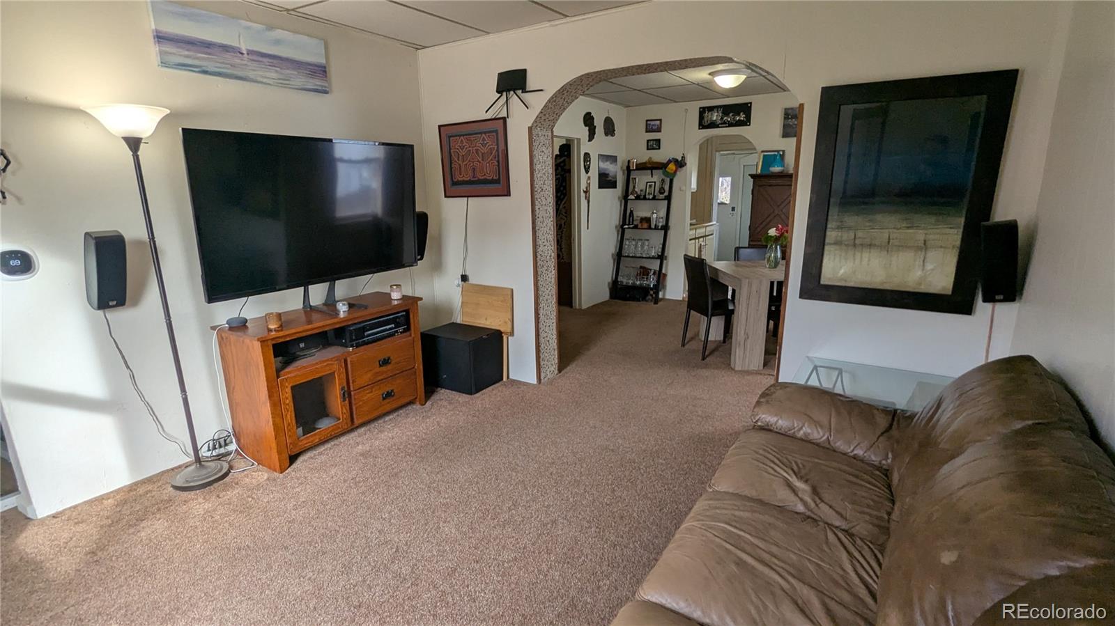 3924 Jason Street Denver, CO 80211 - Photo 6 of 26 a living room with furniture and a flat screen tv