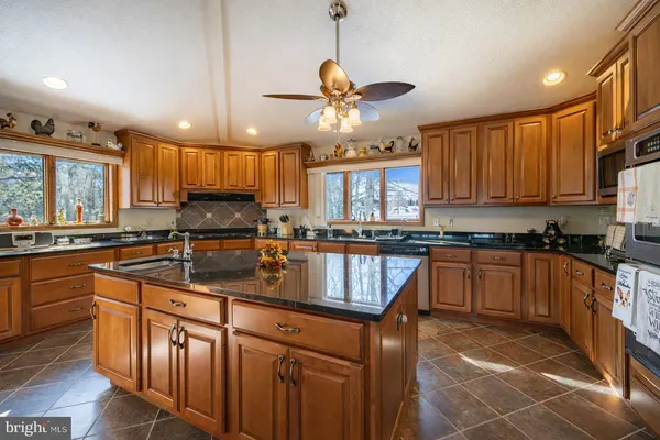 a bathroom with a tub a sink and a large window