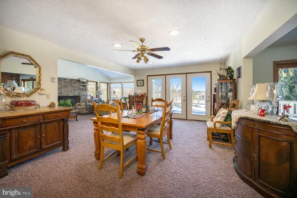 a living room with furniture and a book shelf