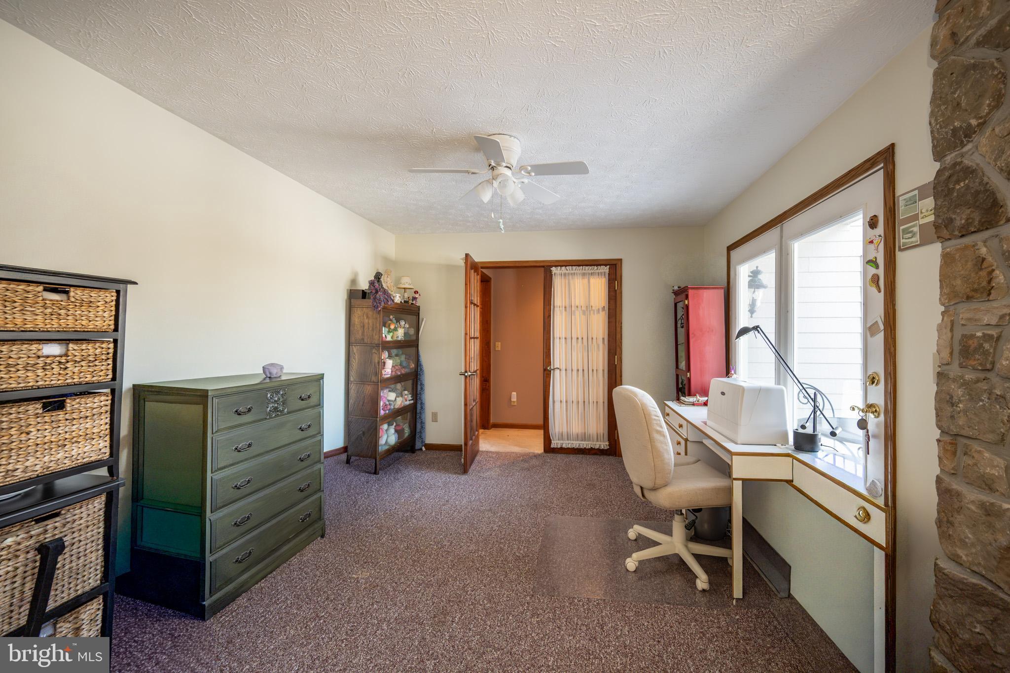 815 Chadderton School Road Oakland, MD 21550 - Photo 23 of 110 a view of a workspace with furniture and a window