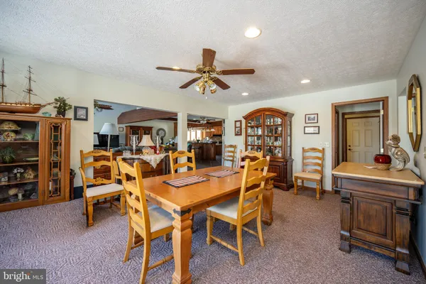 a bedroom with a bed and a dresser next to a window
