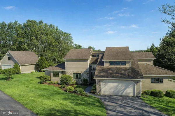 a living room with lots of furniture and a large window