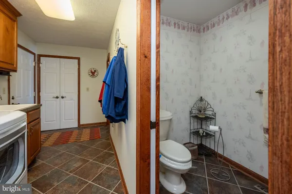 a bedroom with a bed a window and painting on the wall