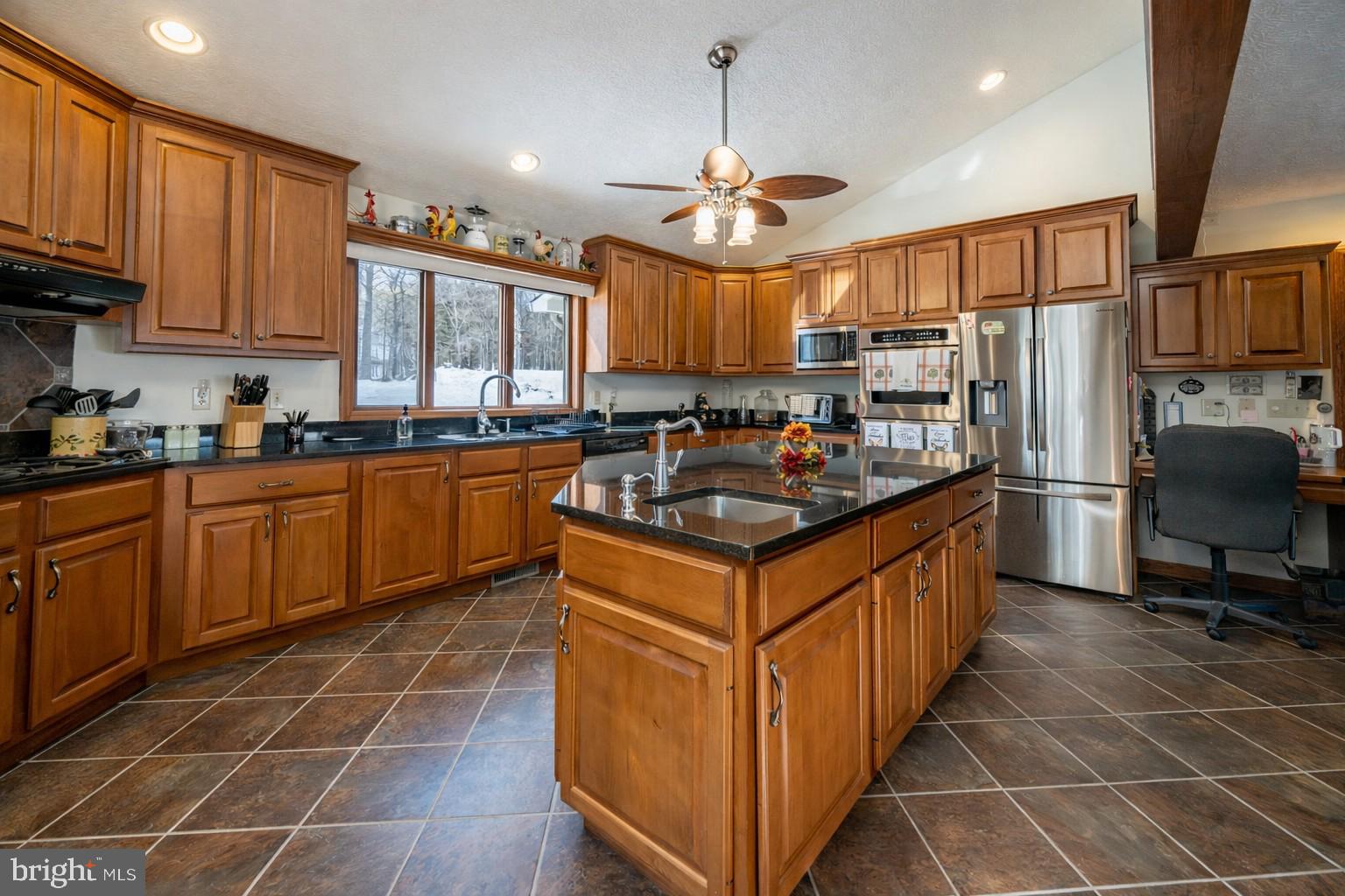 815 Chadderton School Road Oakland, MD 21550 - Photo 5 of 110 a kitchen with stainless steel appliances a sink a stove a refrigerator cabinets and a dining table