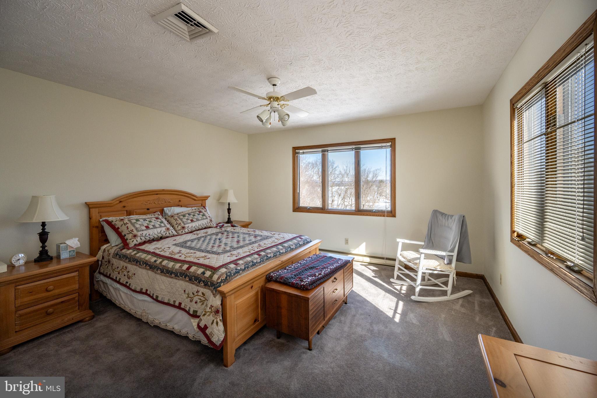 815 Chadderton School Road Oakland, MD 21550 - Photo 51 of 110 a bedroom with a bed chair and window