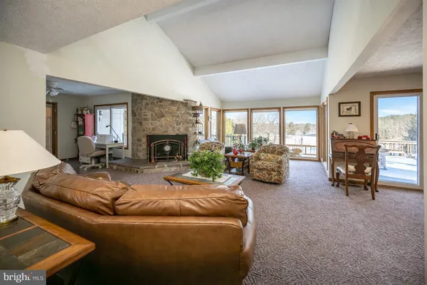 a living room with furniture a dining table and kitchen view
