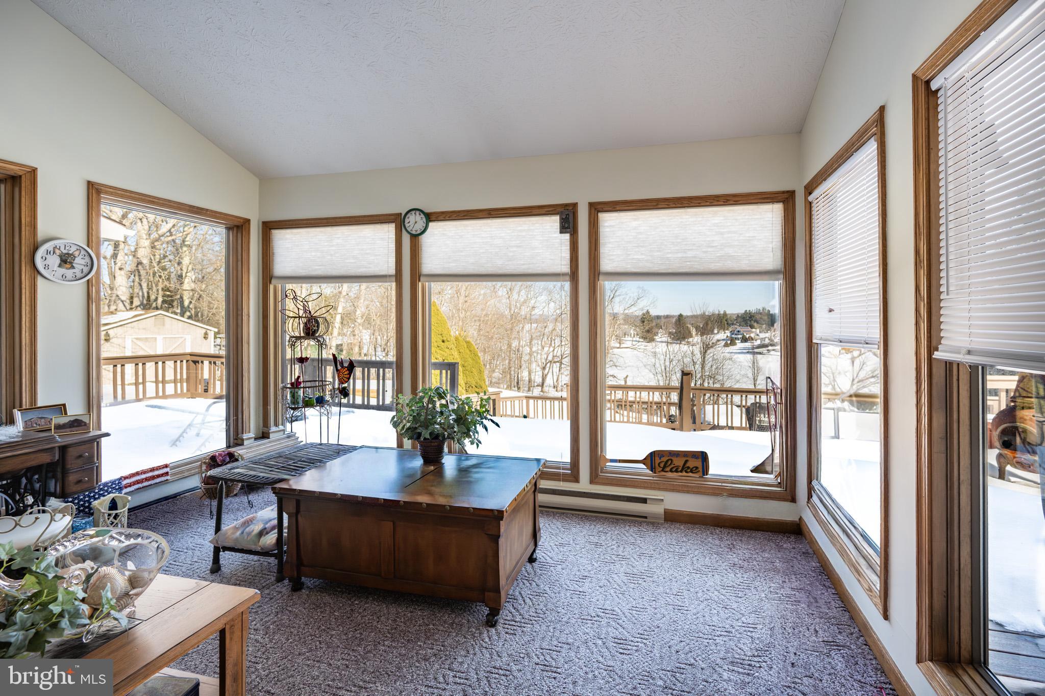 815 Chadderton School Road Oakland, MD 21550 - Photo 10 of 110 a living room with furniture and a floor to ceiling window