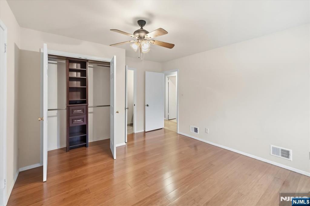 117 Sunset Key, Unit 117 Secaucus, NJ 07094 - Photo 9 of 22 an empty room with wooden floor closet and windows