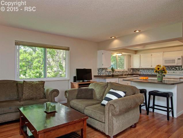 2608 Rigel Drive Colorado Springs, CO 80906 - Photo 11 of 26 2nd living room that is connected to kitchen, great for big get together. Hardwood flooring